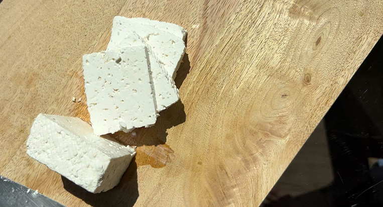 Feta on a cutting board for the Balsamic & Feta Watermelon Salad