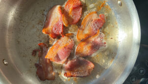 Bacon cooking in a pan.