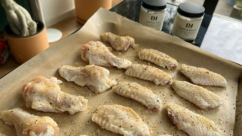 Seasoned wings on parchment paper.